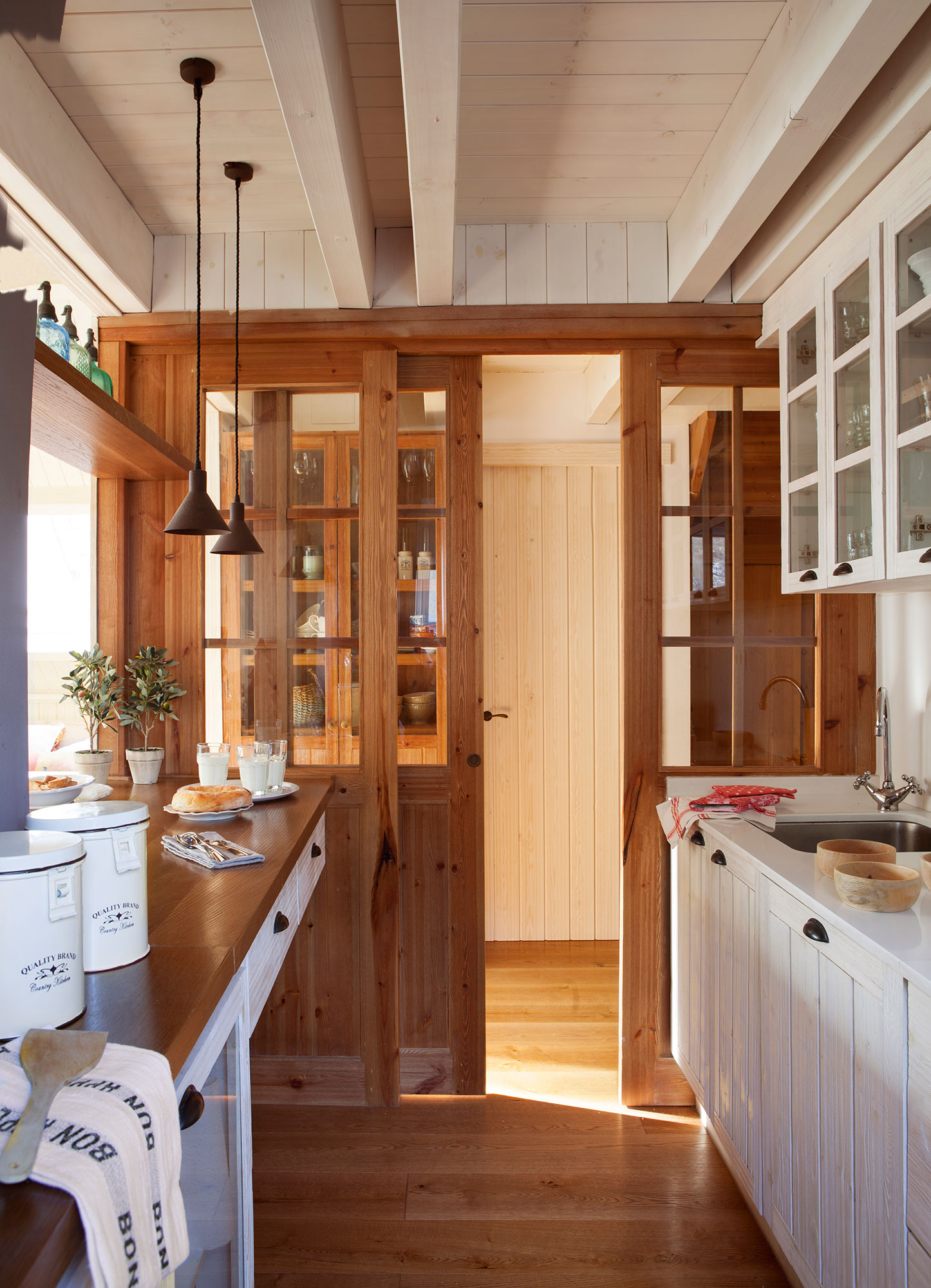 Cocina con puerta corredera de madera y acristalada.