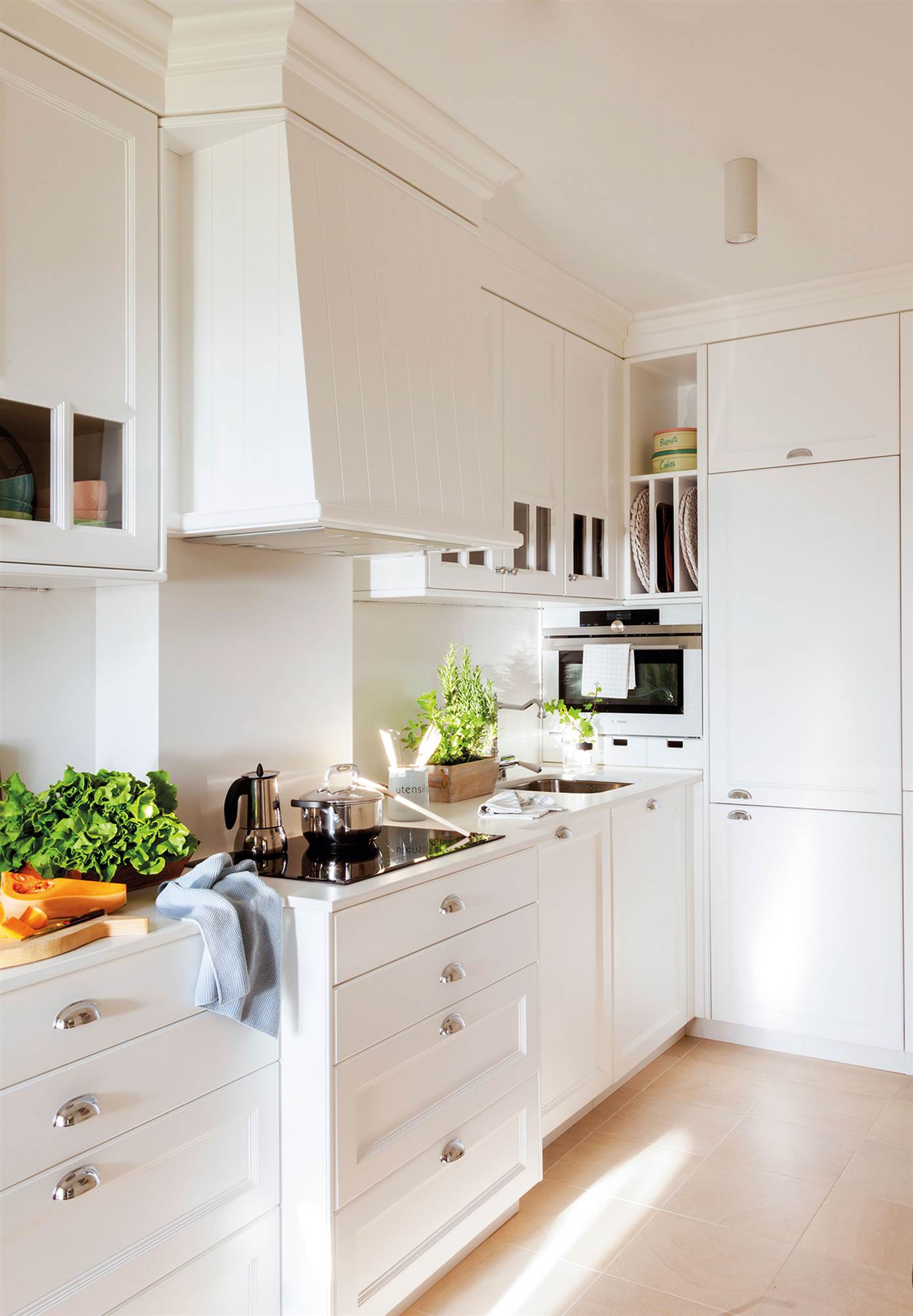 Classic style small kitchen with white furniture. 