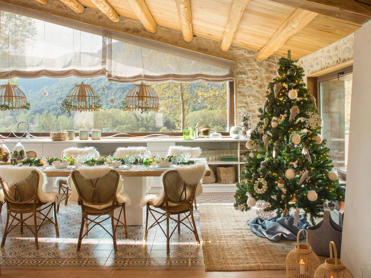 Salón rústico con aires escandinavos con árbol de Navidad adornado de blanco y plateado. 
