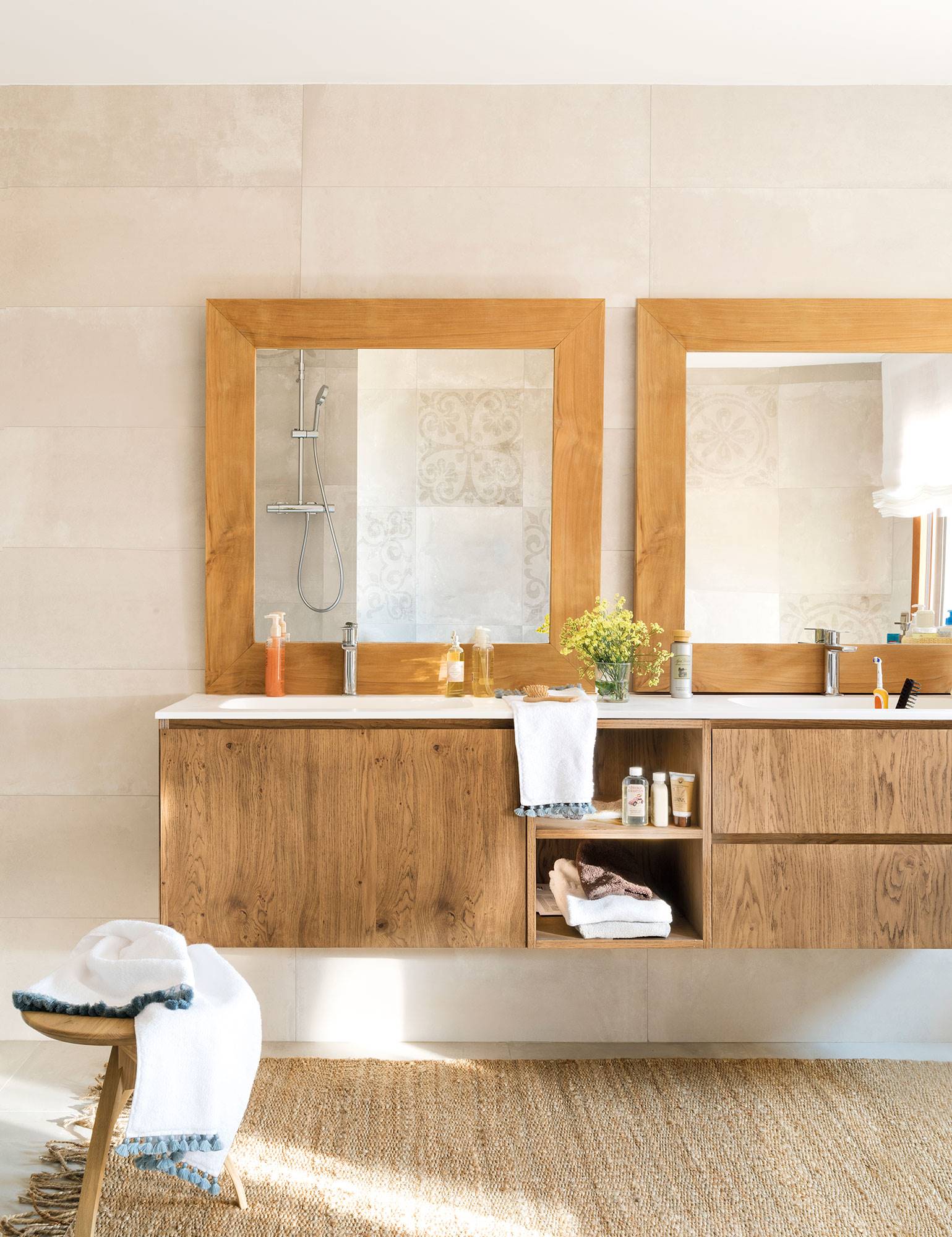 Baño con dos espejos iguales y con marcos de madera.