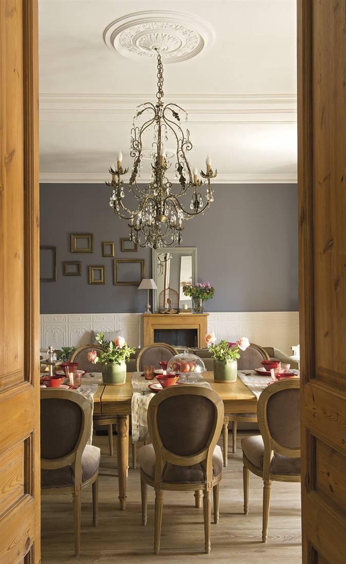 Salón con lámpara de araña y pared en color gris