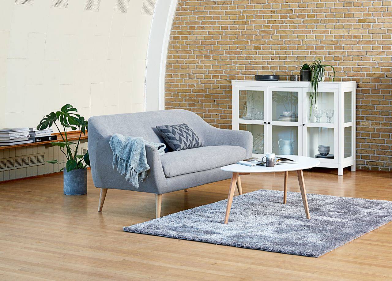 sofa gris mesa de centro blanca aparador