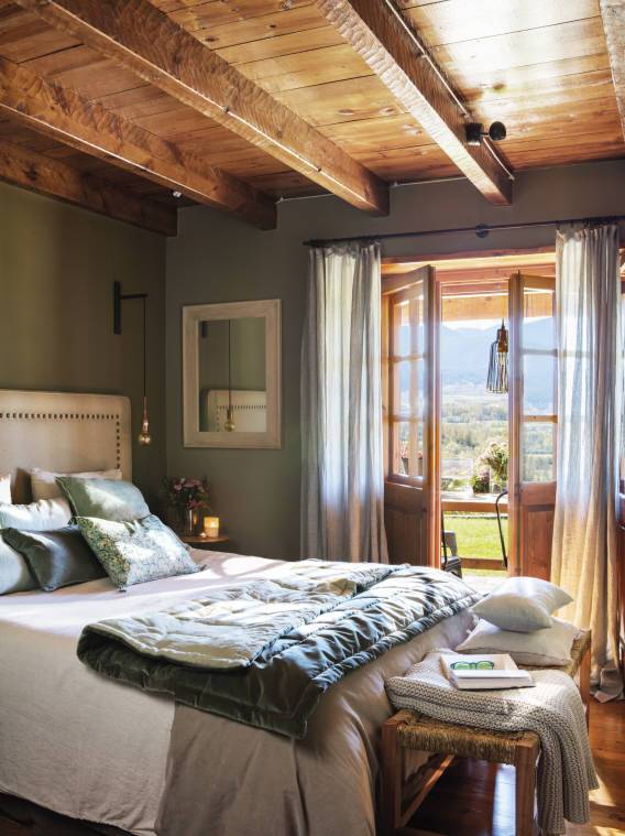 Dormitorio rústico de invierno con techo de madera.