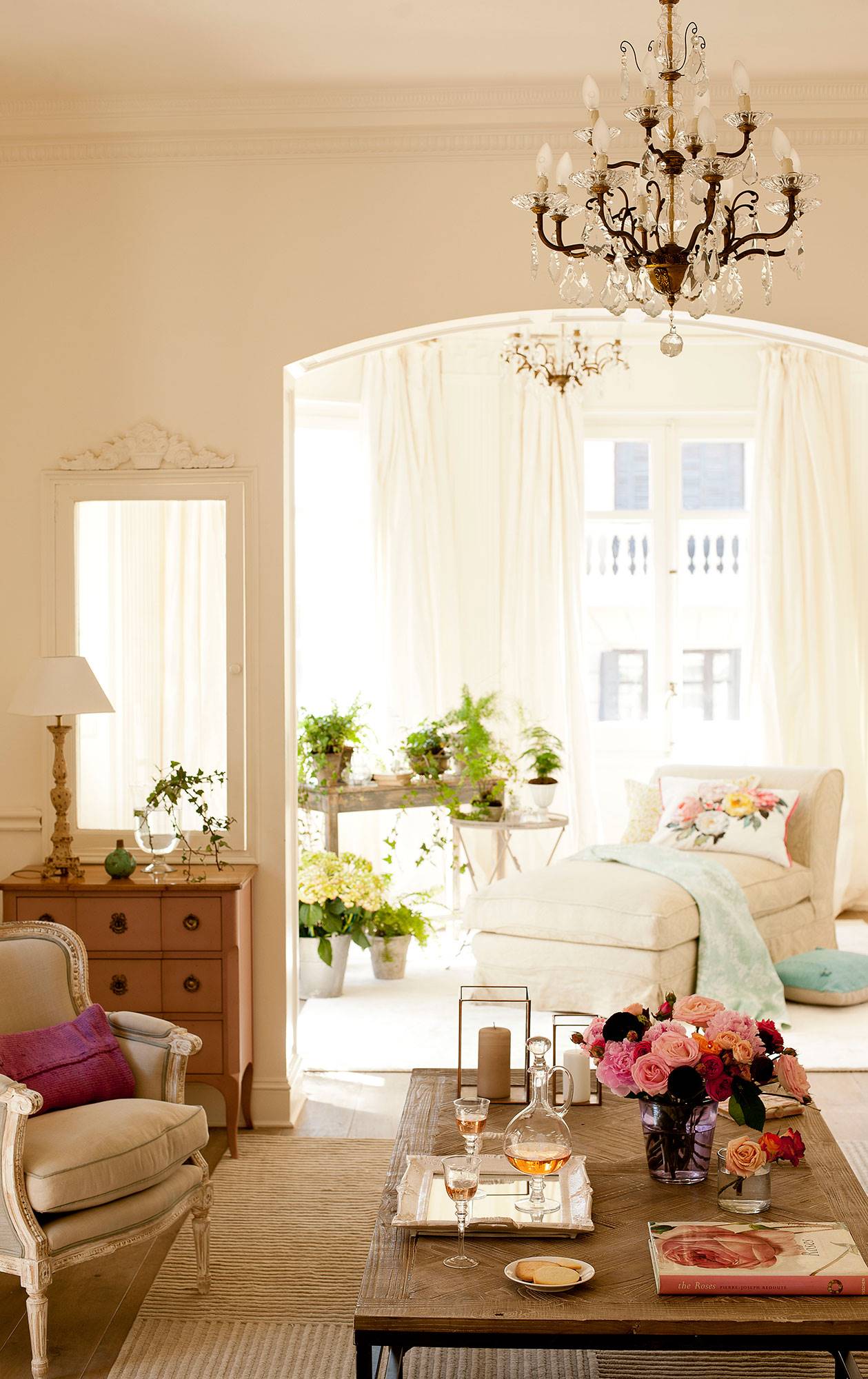 Salón clásico en blanco con chandelier y chaiselongue junto a la ventana