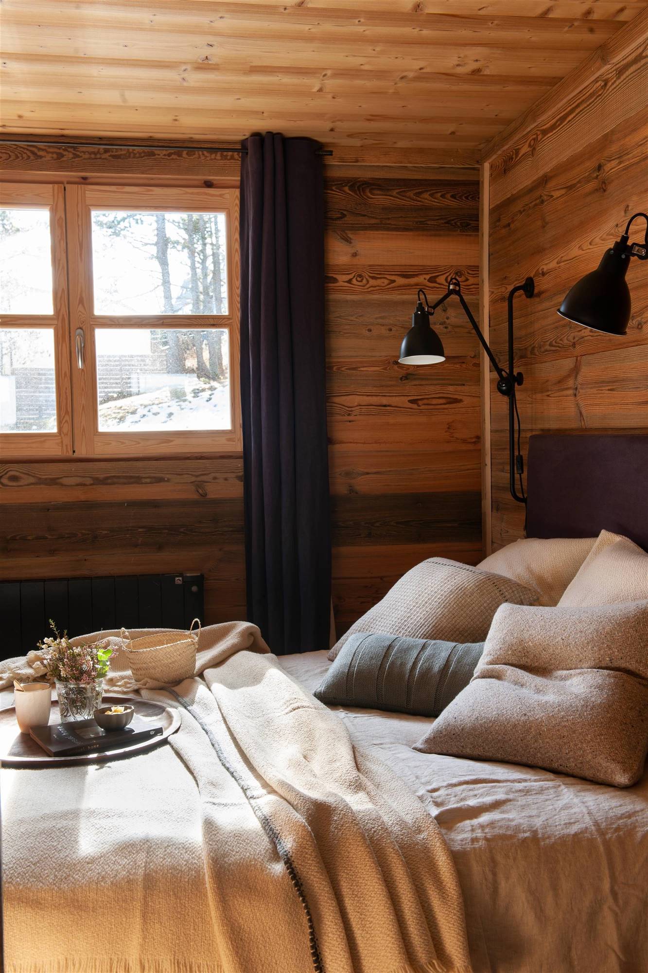 Dormitorio de invierno con paredes de madera.