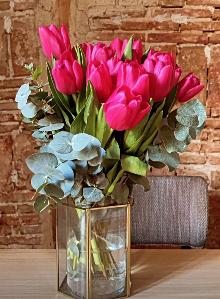 Jarrón de cristal con estructura dorada y tulipanes rosas en casa de Nagore Robles, foto de Instagram