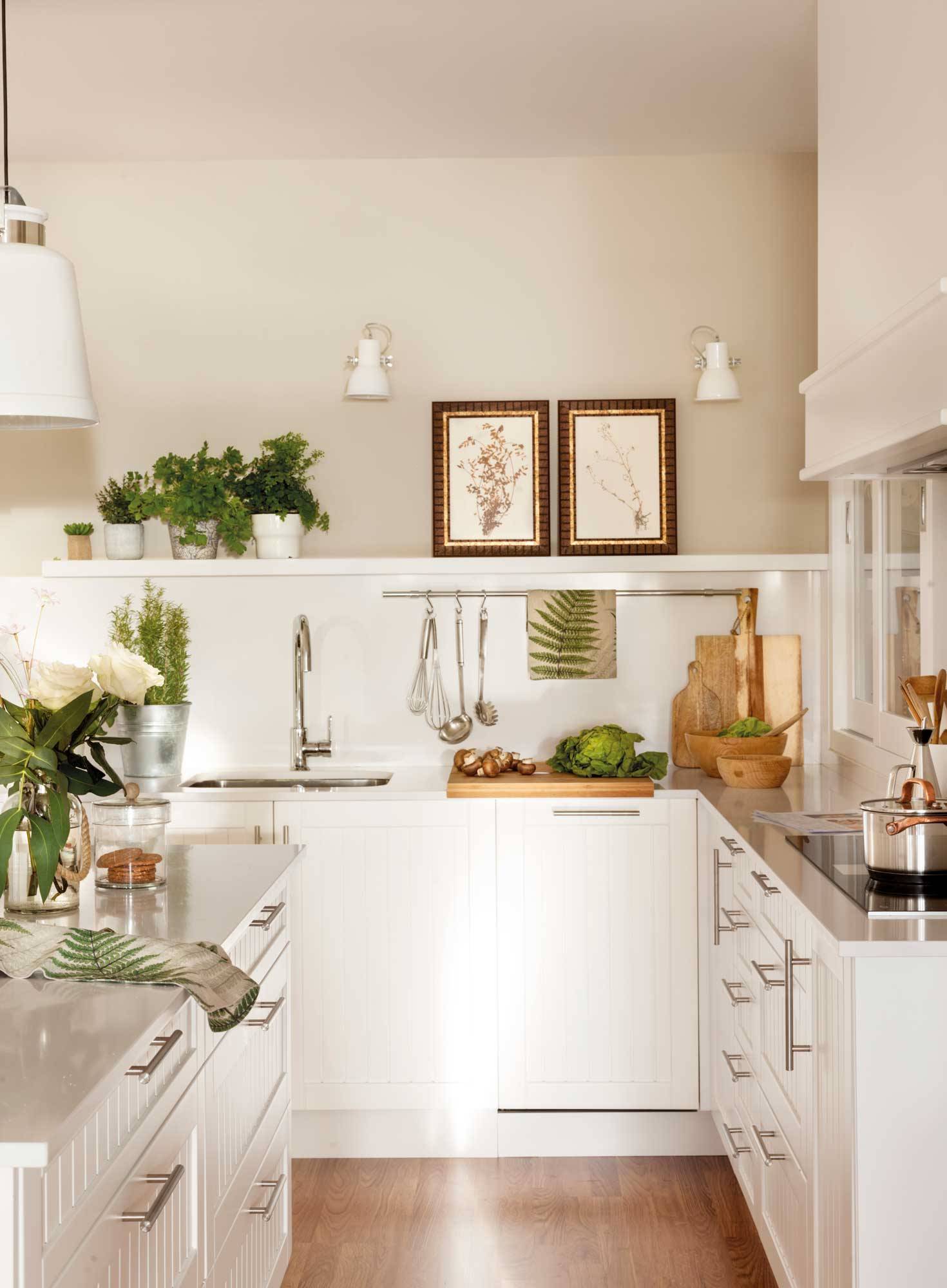 Small kitchen with white fluted furniture. 