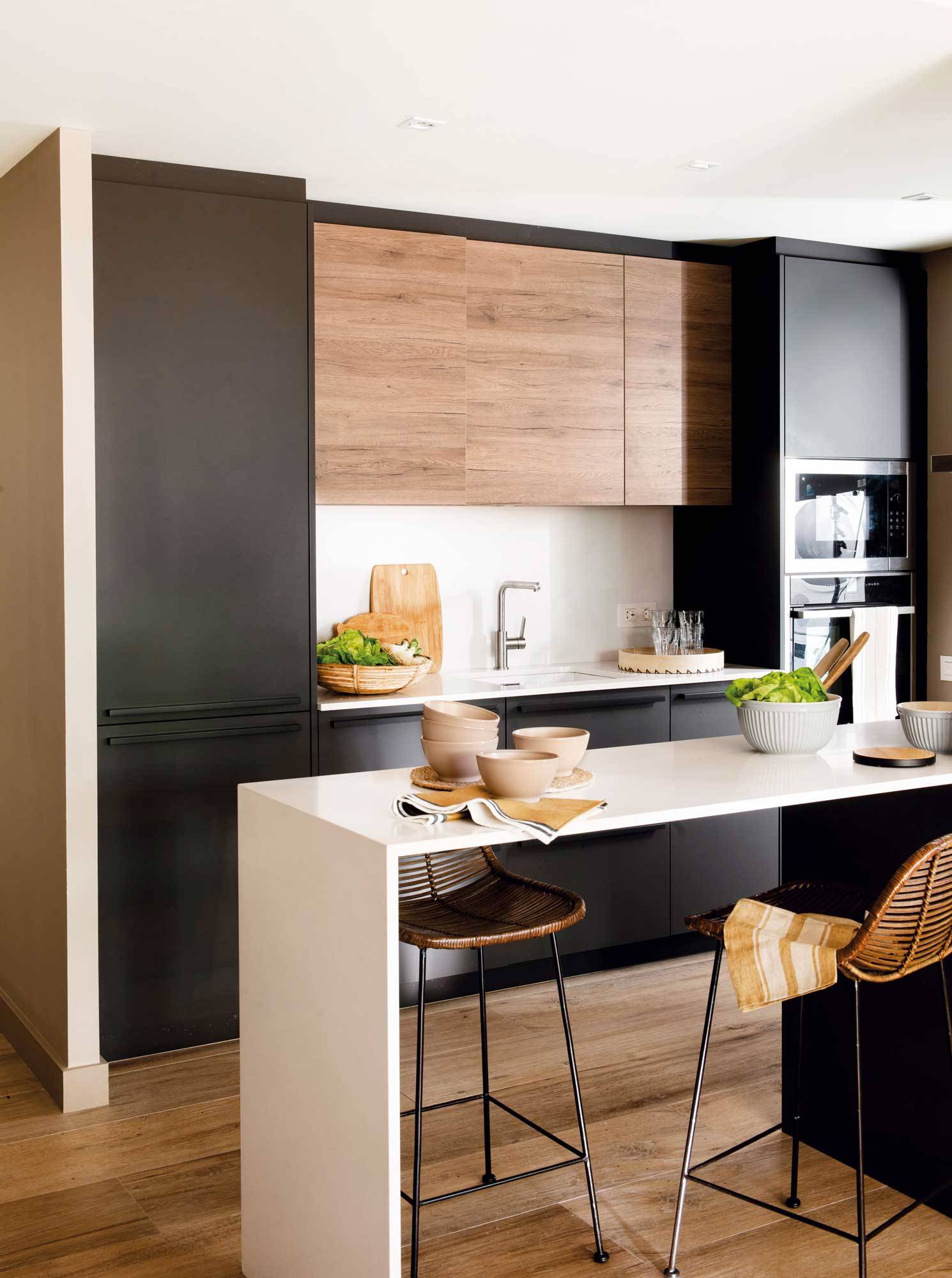 Small kitchen with furniture in wood and black.  