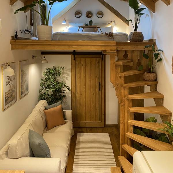 Un dormitorio abuhardillado blanco y de madera