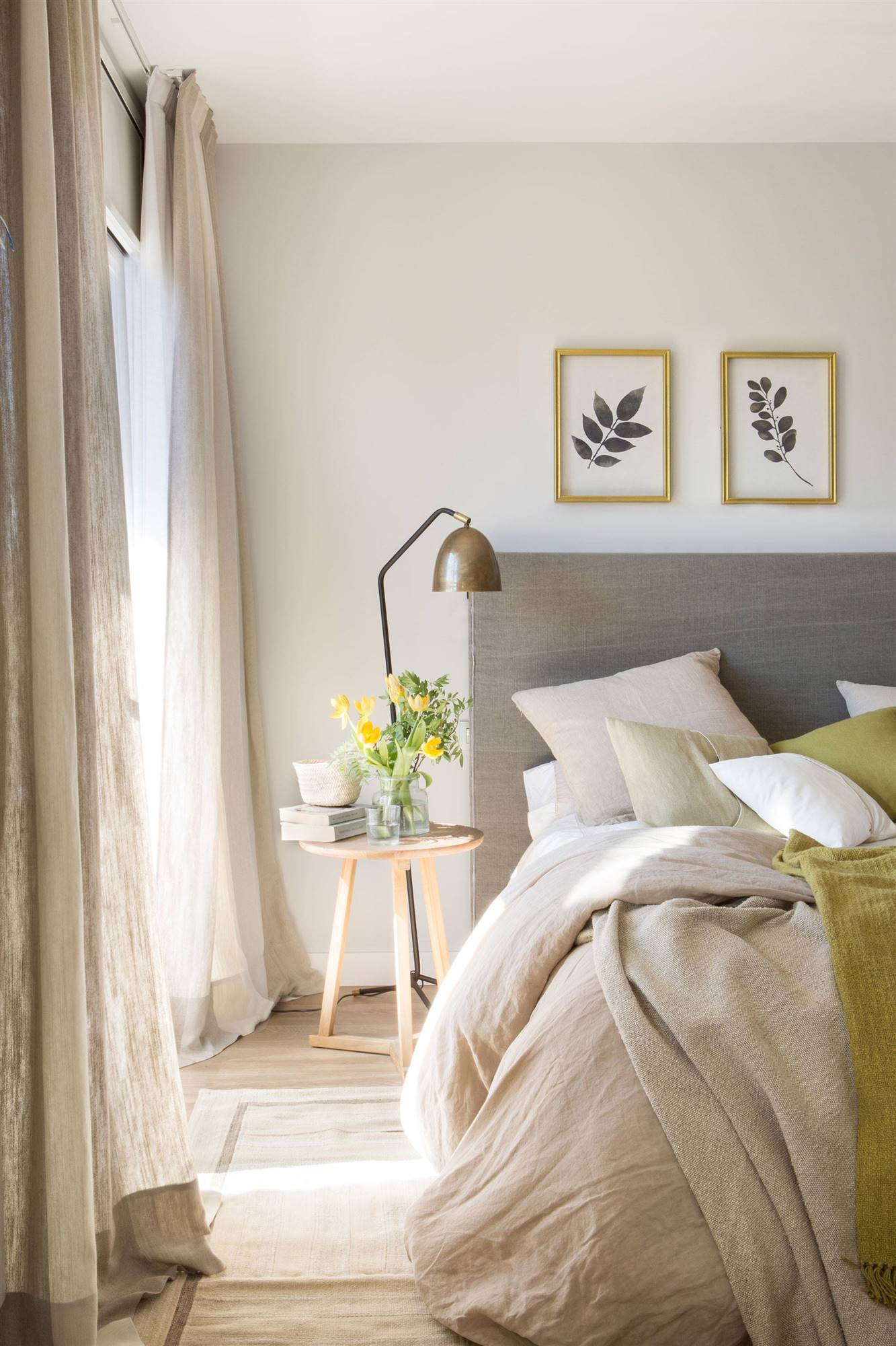 Dormitorio decorado en tonos grises y muebles de madera clara. 