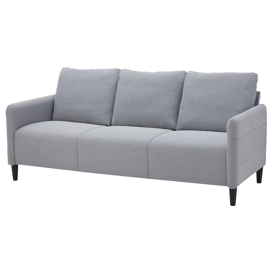 Un sobrio sofá gris con bolsillos laterales