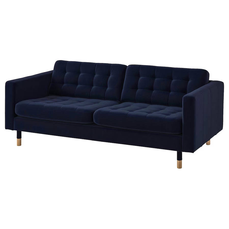 Un sofá de terciopelo azul oscuro