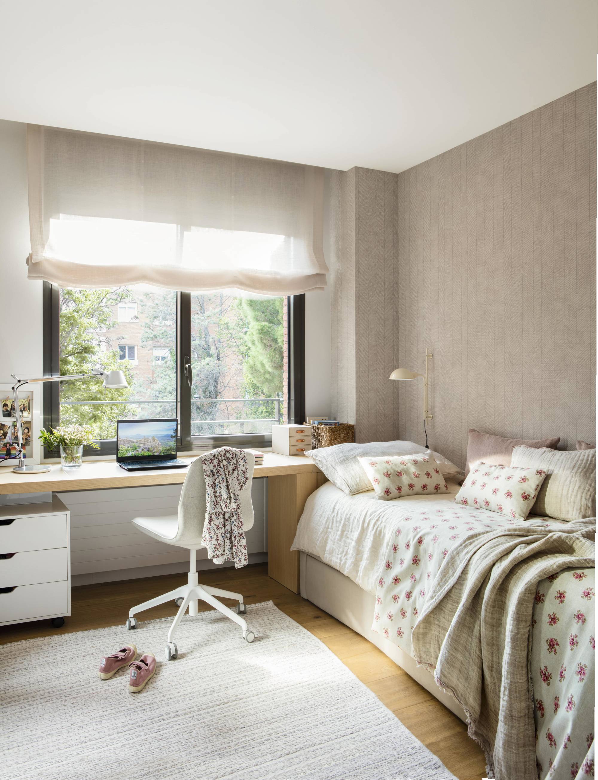 Dormitorio juvenil con cama y escritorio frente la ventana.