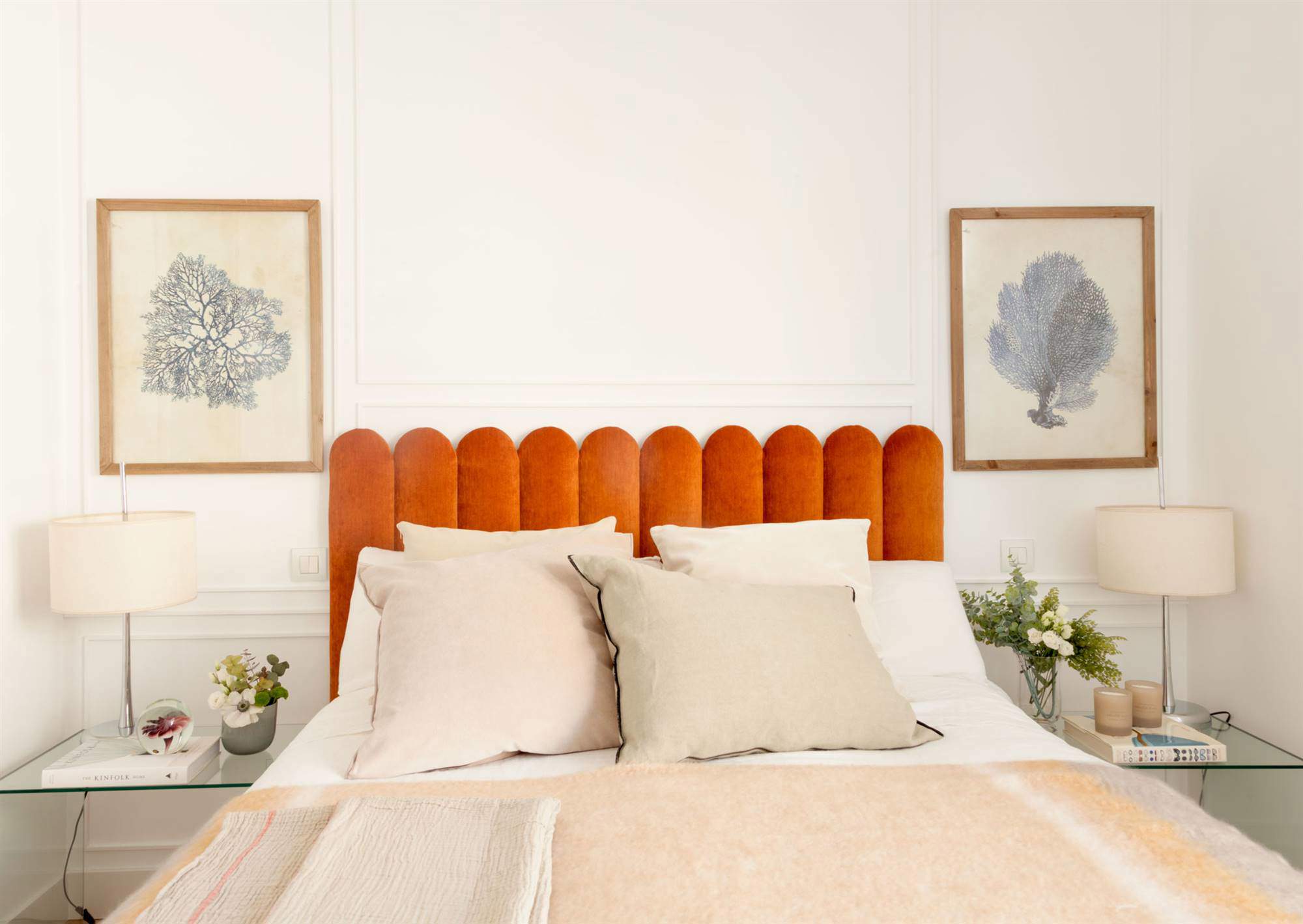 Dormitorio de matrimonio moderno con cabecero de terciopelo naranja y ondulado.
