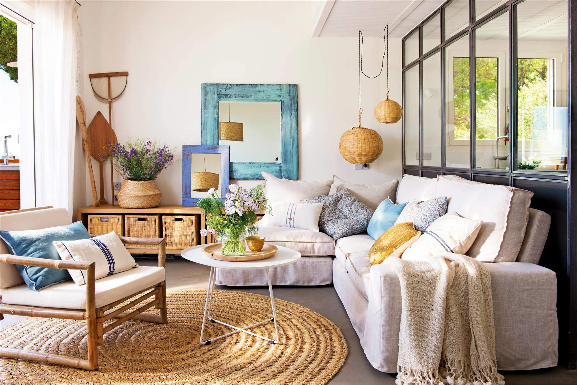 Salón con sofá blanco, muebles de madera y alfombra de fibra.