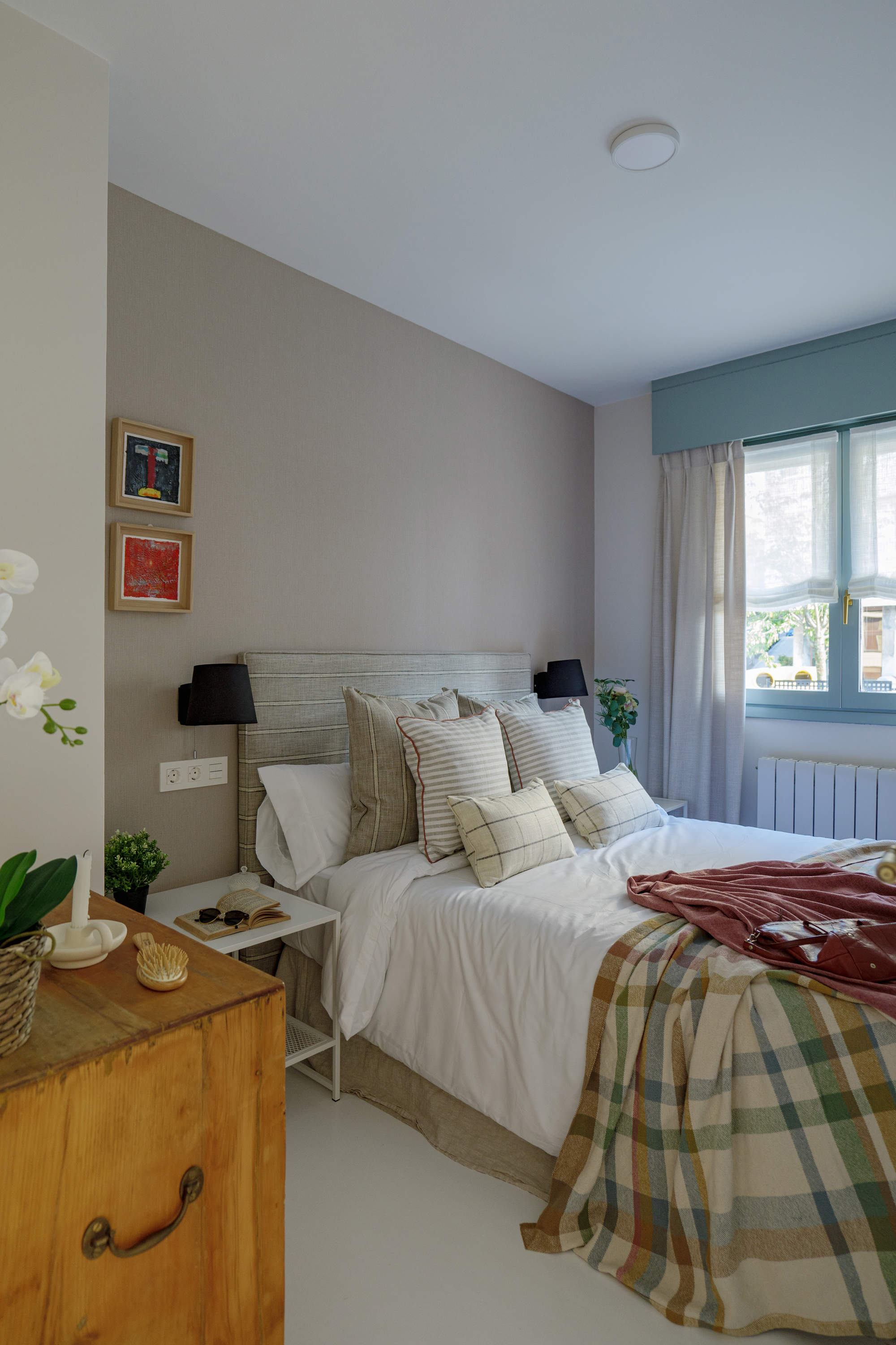 Dormitorio infantil con suelo blanco y textiles de cama en tonos beige