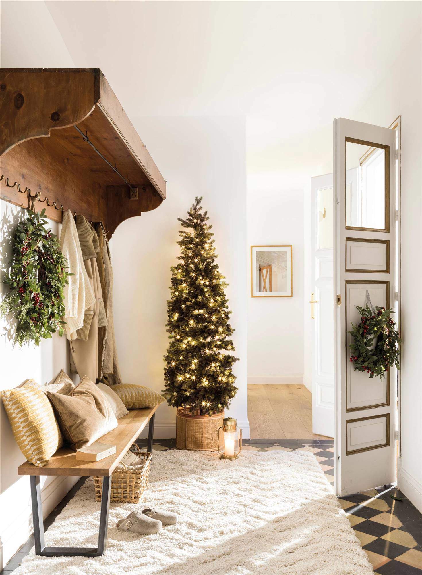 Recibidor decorado con árbol de Navidad con luces doradas.
