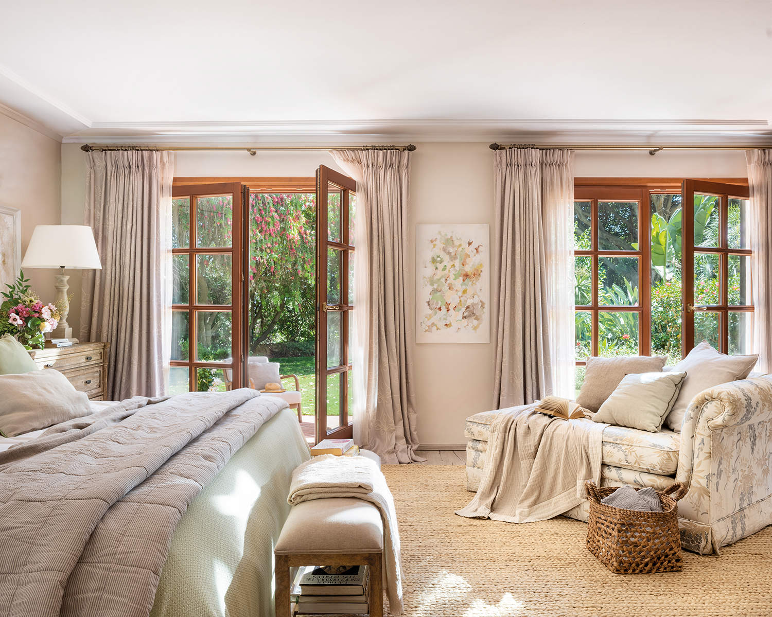 Dormitorio cálido con cabezal tapizado beige y chaiselonge