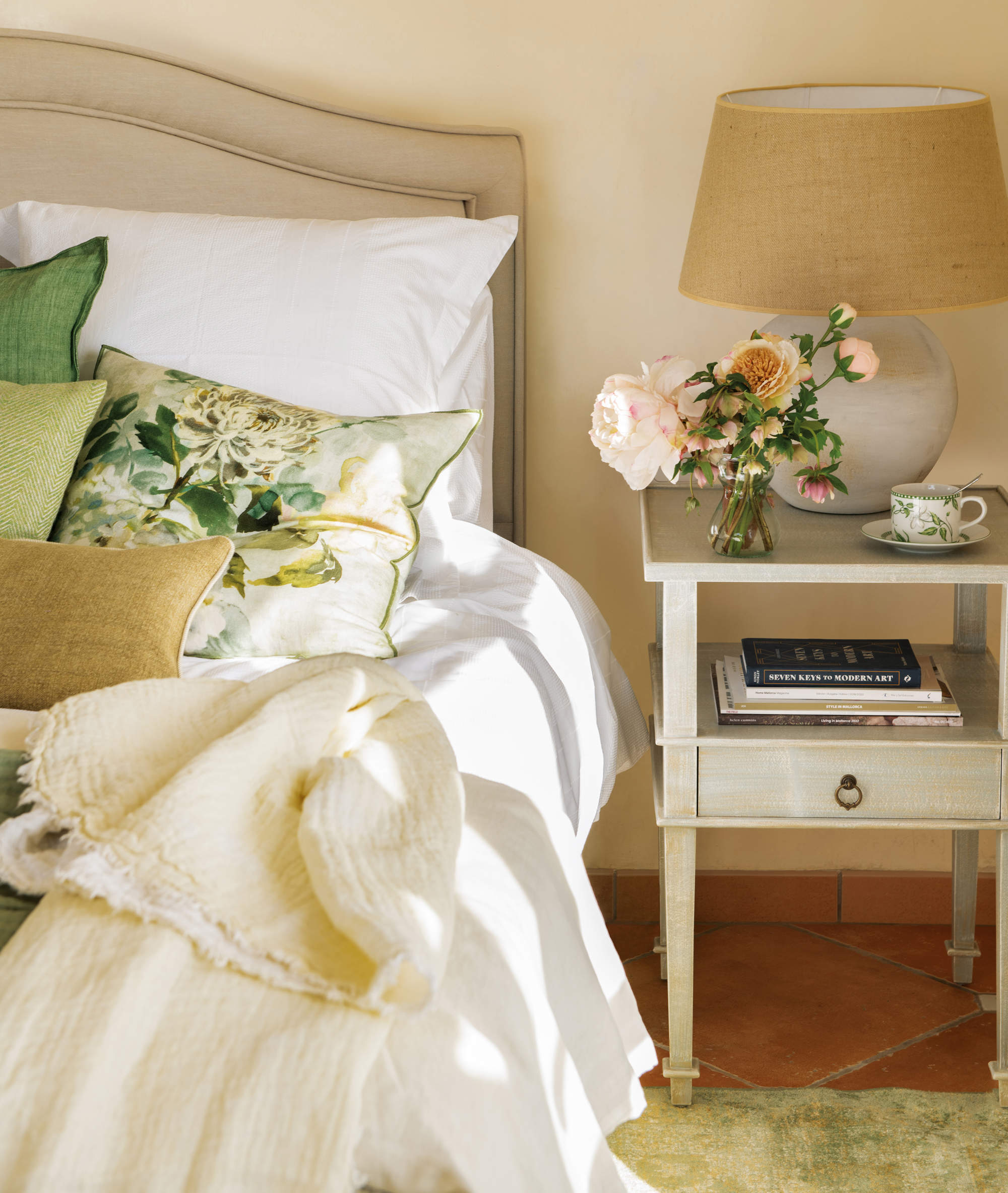 Dormitorio de estilo clásico con cojines lisos y estampado con flores.