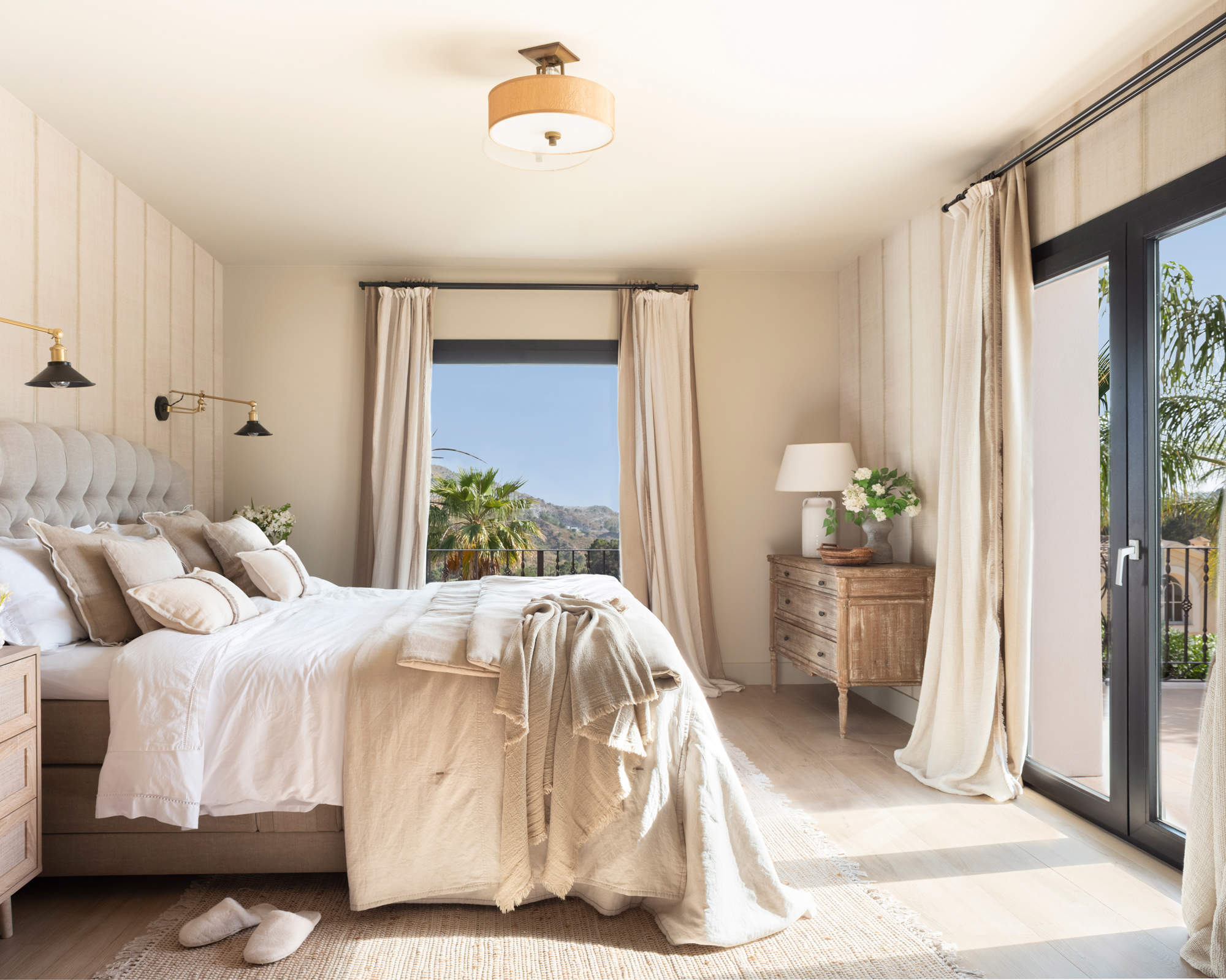 Dormitorio moderno con cómoda antigua y cortinas arrastrando