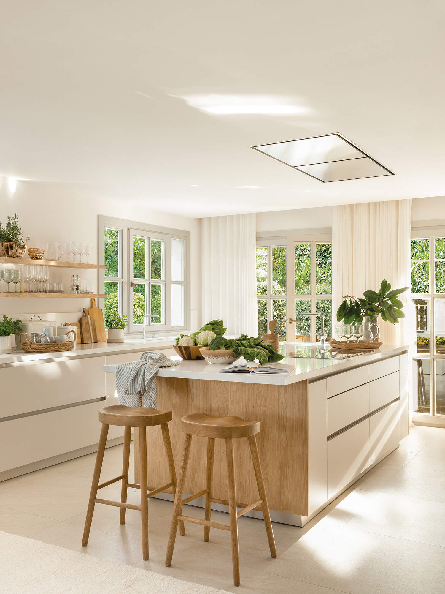 Cocina con isla, muebles blanco y suelo neutro