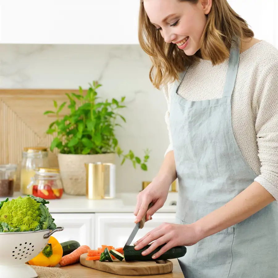 mujer en una cocina cortando verdura_00476193_O