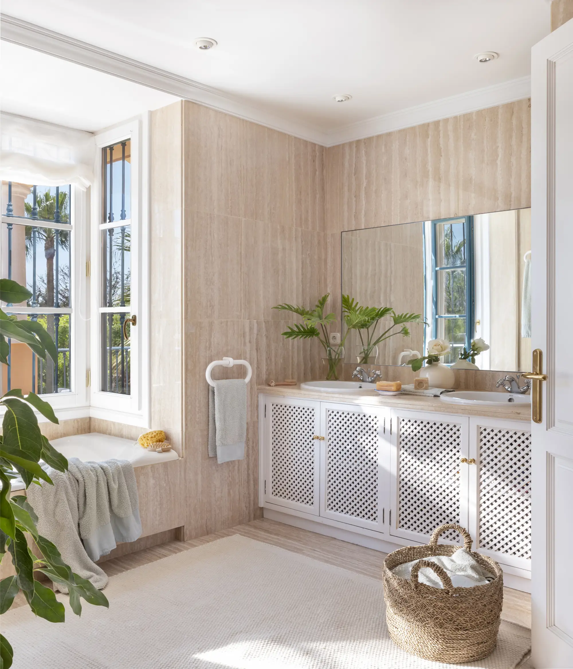 Baño con mueble de lavabo blanco con puertas mallorquinas