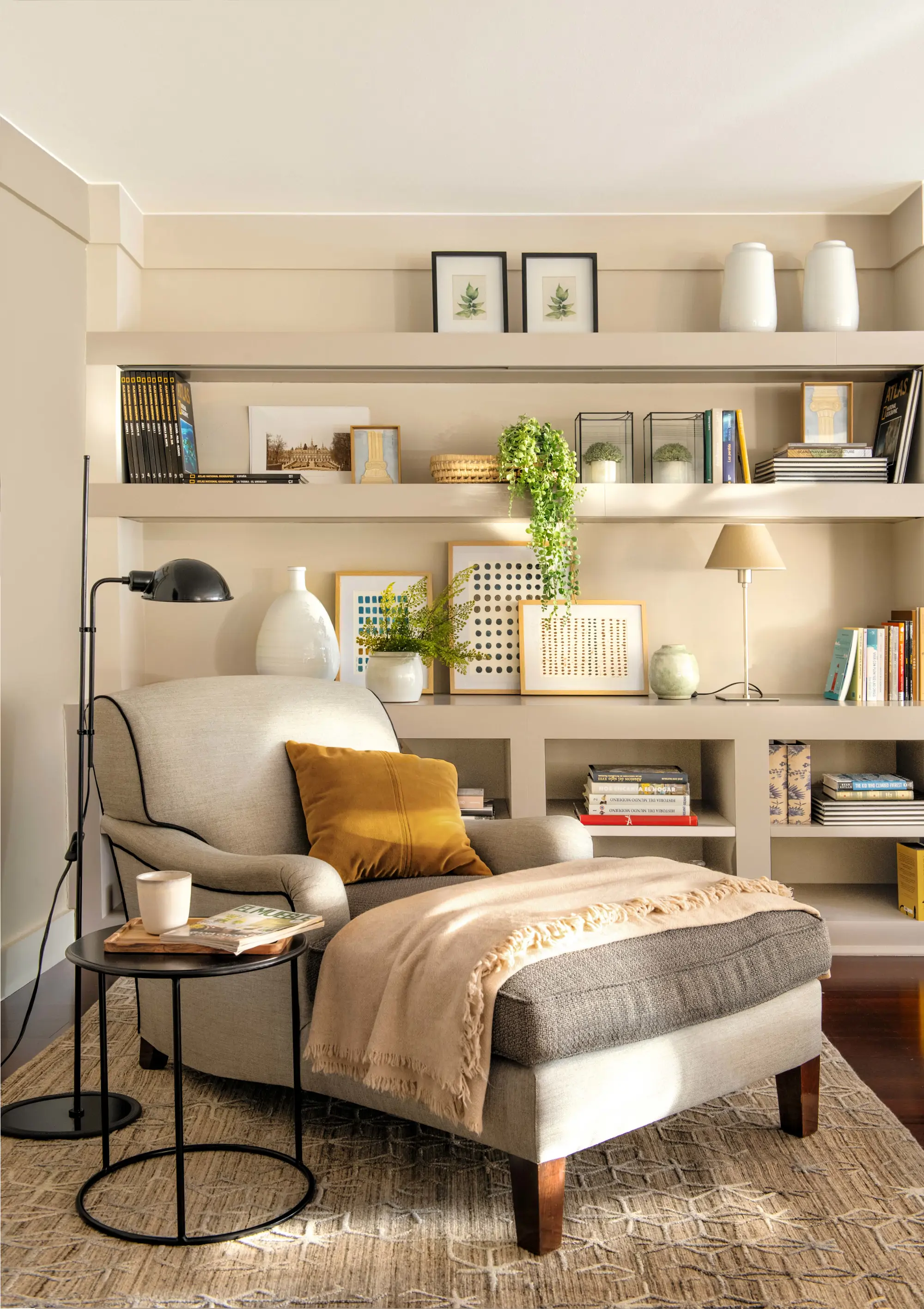 Zona de lectura en salón con chaise longue, mesa auxiliar y lámpara de pie