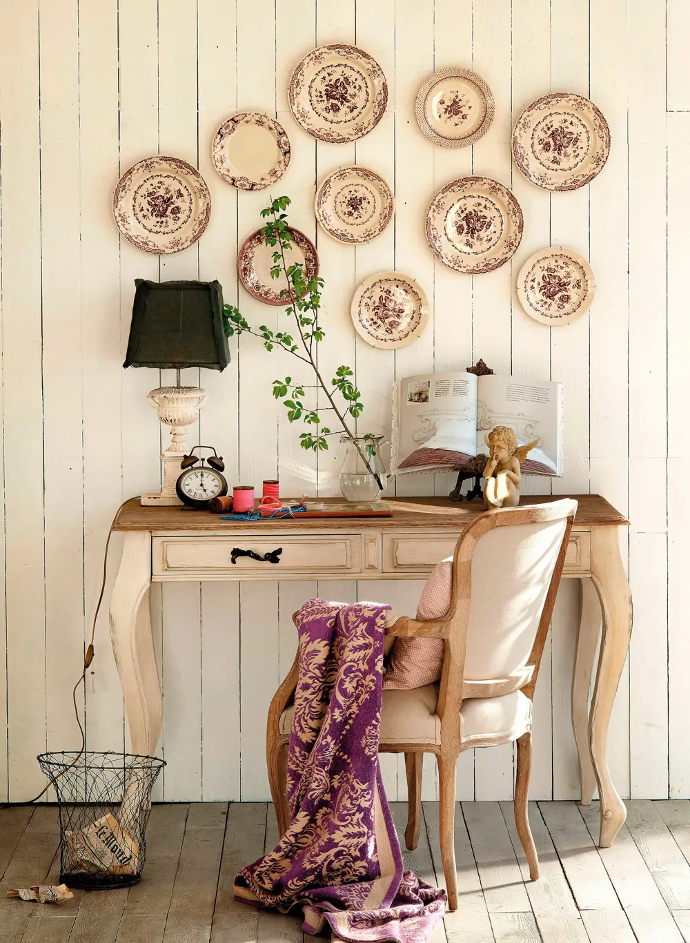 Rincón vintage con escritorio y platos decorando la pared