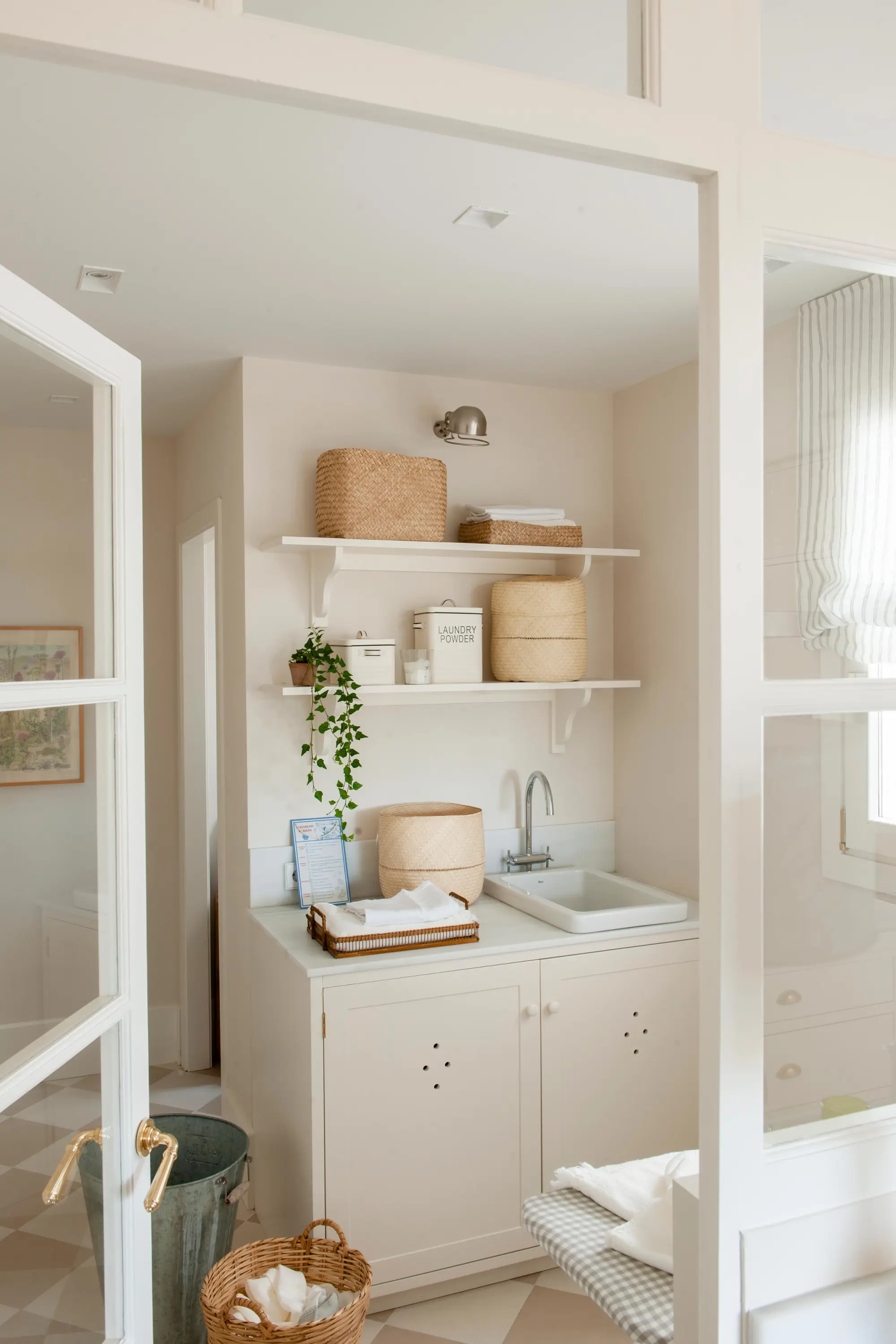 Lavadero con muebles con respiradero y baldas blancas en pared