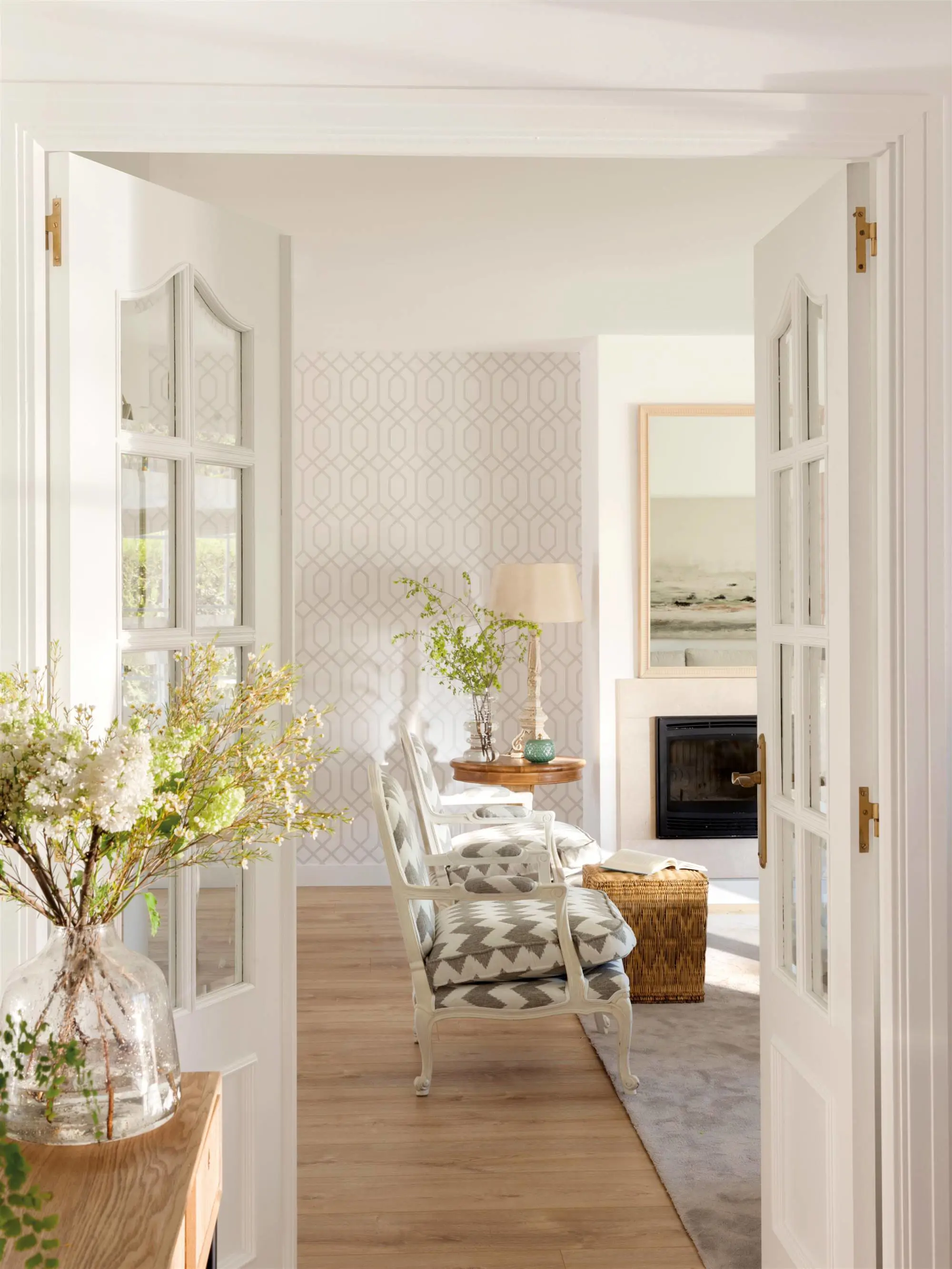 Recibidor con puertas blancas con cristal que acceden al salón.