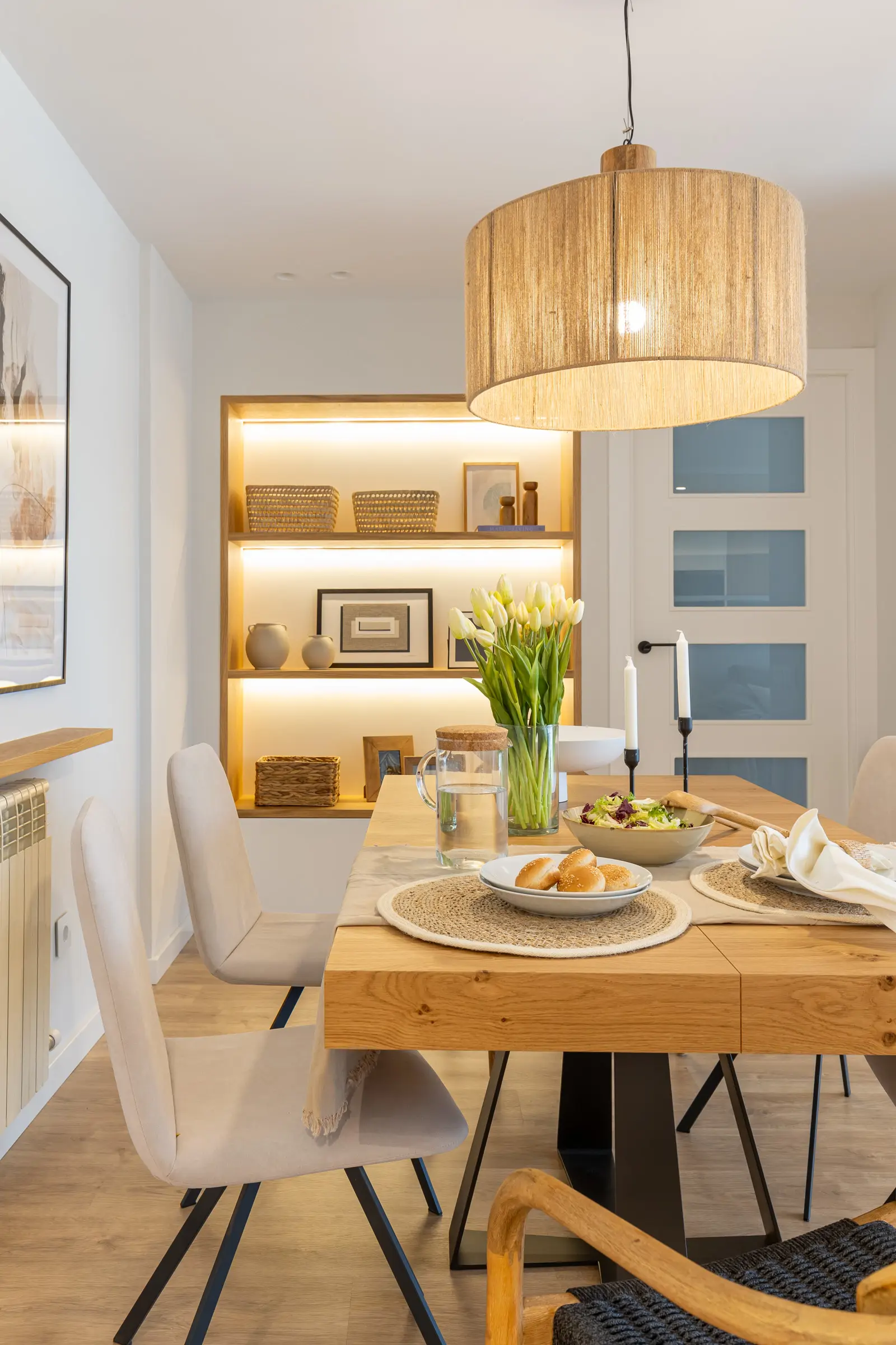 Comedor con mesa de madera maciza y patas de hierro y sillas tapizadas en gris