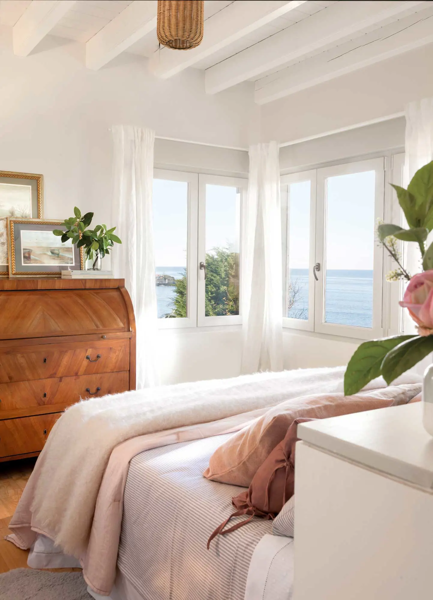 Dormitorio con cómoda antigua a los pies de la cama